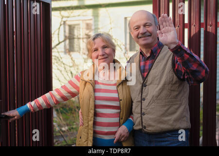 Mature parents meeting their children waving hands. Stock Photo
