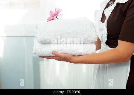 Maid With Fresh Clean Towels During Housekeeping In A Hotel Room