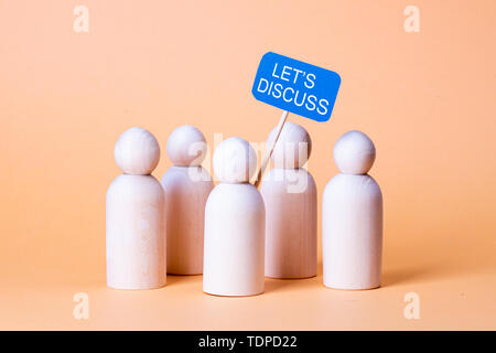 Wooden figures with the slogan Let's discuss Stock Photo