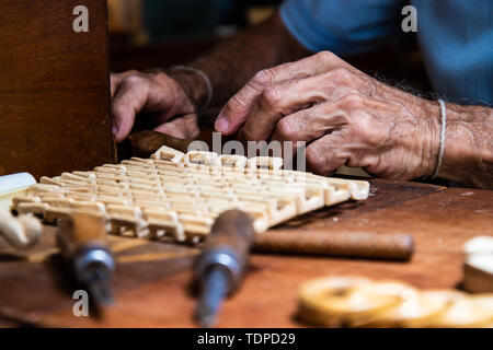 Carpenter with chisel in the hands on the workbench Stock Photo