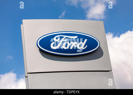 Sign with the logo of Ford Motor Company.  American multinational automaker that has its main headquarters in Dearborn, Michigan, a suburb of Detroit. Stock Photo