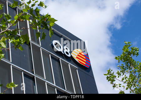 Sign on building facade with the logo of Q8, Kuwait Petroleum International. Q8, refines and markets fuel, lubricants and other petroleum products in  Stock Photo