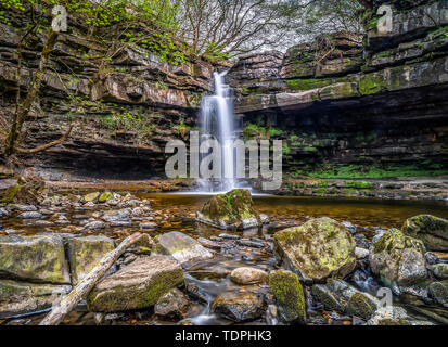 Summerhill Force is a picturesque waterfall in a wooded glade in Upper Teesdale. Heavily undercut, the recess behind the fall is known as 'Gibson's... Stock Photo