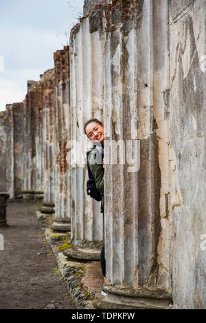 A young female tourist poses at ruins; Pompei, Italy Stock Photo