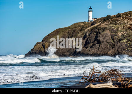 Waves crash on the rocks below the Cape Disappointment North Head Lighthouse near Ilwaco; Washington, United States of America Stock Photo