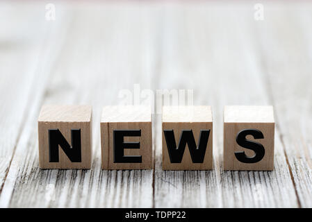 Wooden news sign on a wooden background Stock Photo