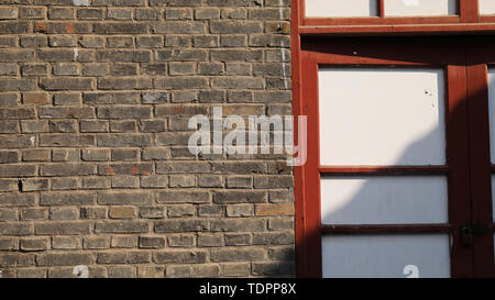 Nostalgic brick walls, mottled tree shadows Stock Photo