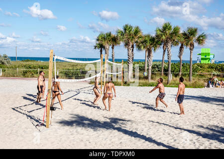 Miami Beach Florida,North Beach,beach volleyball court,sand,playing man,woman female women,young adult,bathing suit,bikini,body image,FL190104063 Stock Photo