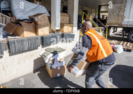 Miami Florida,Salvation Army donations,Black man men male,car trunk,lifting carrying boxes,receiving donations,worker,reflective vest,loading dock,FL1 Stock Photo