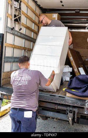 Miami Beach Florida,North Beach,delivery,Hispanic Latin Latino ethnic immigrant immigrants minority,adult adults man men male,unloading furniture dres Stock Photo