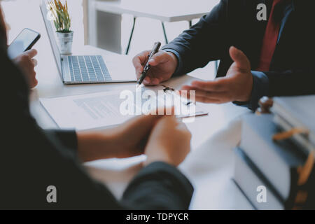 lawyer insurance broker consulting giving legal advice to couple customer about buying renting house. financial advisor with mortgage loan investment  Stock Photo