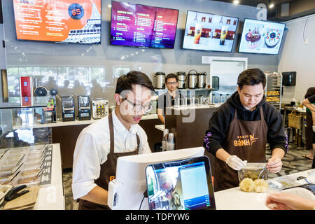 Orlando Florida,East Colonial Drive,Little Saigon,Asian Paris Banh Mi Cafe Bakery,Vietnamese bakery sandwich shop,man men male,young adult,counter ser Stock Photo