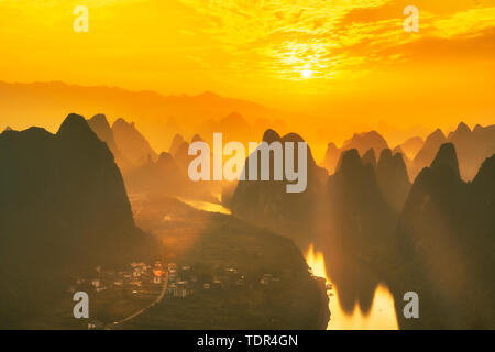 Sunrise silhouette of Guilin landscape and bamboo rafts on the Li River Stock Photo