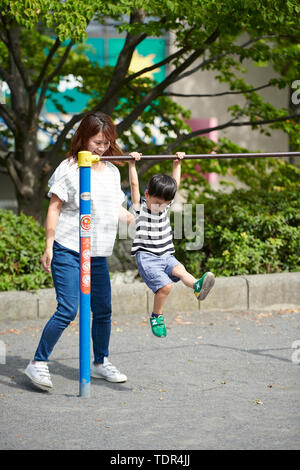 Japanese family in a city park Stock Photo