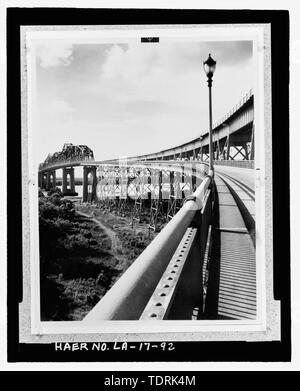 Photographic copy of circa 1934, black and white photograph. Located loose in oversized box at the National Museum of American History, Smithsonian Institution, Archives Center, Work and Industry Division, Washington, D.C. Original Photographer unknown.; CIRCA 1934 PHOTOGRAPH TAKEN ON WEST BANK APPROACH ROADWAY LOOKING NORTHEAST TOWARD EAST BANK SHOWING DETAIL OF RAILING AND DECORATIVE LIGHT STANDARD AND FIXTURE. - Huey P. Long Bridge, Spanning Mississippi River approximately midway between nine and twelve mile points upstream from and west of New Orleans, Jefferson, Jefferson Parish, LA; Modj