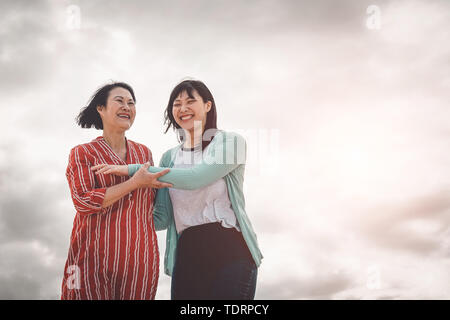 Asian mother and daughter having fun outdoor - Happy Chinese family  enjoying time together outside Stock Photo