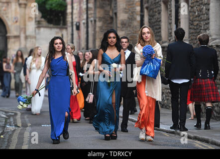 Students from Cambridge University make their way home along Trinity Lane after celebrating the end of the academic year at a May Ball in Trinity College. Stock Photo