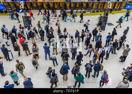 London, UK. 18th June, 2019. Crowds build up due to a reduced service because of the strike by RMT staff on SW Trains,  but are not as heavy as expected. Passengers wait for news of their trains on the concourse of Waterloo Station, London. Credit: Guy Bell/Alamy Live News Stock Photo