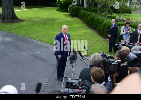 Washington, District of Columbia, USA. 18th June, 2019. United States President Donald J. Trump takes questions from the media as he walks from the Oval Office as he prepares to depart the South Lawn of the White House in Washington, DC for Orlando Florida where the President will formally announce he is a candidate for re-election on Tuesday. June 18, 2019 Credit: Ron Sachs/CNP/ZUMA Wire/Alamy Live News Stock Photo