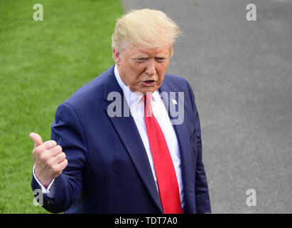 Washington, District of Columbia, USA. 18th June, 2019. United States President Donald J. Trump takes questions from the media as he walks from the Oval Office as he prepares to depart the South Lawn of the White House in Washington, DC for Orlando Florida where the President will formally announce he is a candidate for re-election on Tuesday. June 18, 2019 Credit: Ron Sachs/CNP/ZUMA Wire/Alamy Live News Stock Photo