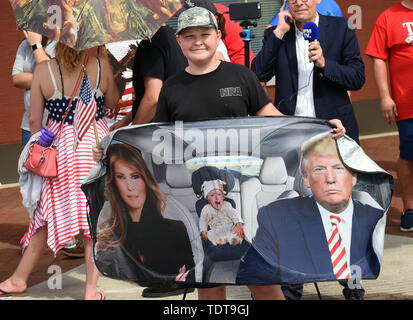 Orlando, Florida, USA. 18th June, 2019. A young boy poses while waiting in line for U.S. President Donald Trump's Make America Great Again rally at the Amway Center on June 18, 2019 in Orlando, Florida. This is the kick-off event for Trump's campaign for re-election in 2020. Credit: Paul Hennessy/Alamy Live News Stock Photo