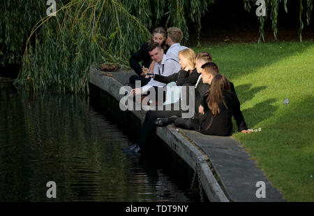 Cambridge, Cambridgeshire, UK. 18th June, 2019. University students are caught in the rays of early morning sunshine after celebrating the end of their University exams and attending the Trinity May Ball, Cambridge, Cambridgeshire, on June 18, 2019. Credit: Paul Marriott/Alamy Live News Stock Photo