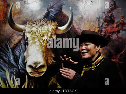 (190619) -- LHASA, June 19, 2019 (Xinhua) -- Wu Yuchu speaks during a yak-themed oil painting exhibition at the Yak Museum in Lhasa, capital of southwest China's Tibet Autonomous Region, May 14, 2019.     Over 40 years ago, Wu Yuchu was trapped in a blizzard in southwest China's Tibet Autonomous Region.      It was 1977, two years after Wu had started working in Tibet. He and more than 50 other people had to hide in a mud-brick house. Temperatures outside dropped to minus 30 degrees Celsius, and food was running out. Hope seemed to be fading away.      When the rescue team finally found them w Stock Photo
