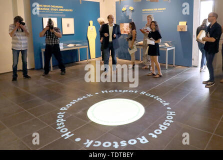 Rostock, Germany. 19th June, 2019. Steffen Stuth (M), Museum Director, presents the new exhibition 'People - Knowledge - Life Paths' at a press event in the Monastery of the Holy Cross. The name 'Hotspot Rostock' is projected onto the floor. From 20.06.2019 the show will present aspects from 600 years of Rostock university and science history. Credit: Bernd Wüstneck/dpa-Zentralbild/dpa/Alamy Live News Stock Photo