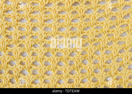 Dark Yellow Knitting Pattern or Knitted Pattern Background in macro style. Knitting Pattern or Knitted Pattern in vintage style for design Stock Photo