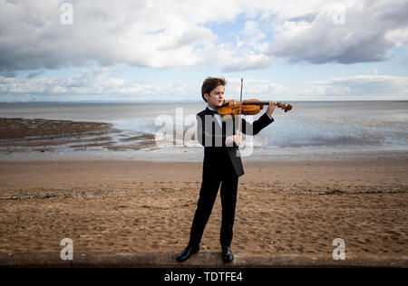 Viktor Seifert, 12, from St Mary's Music School in Edinburgh, plays the Orca Driftwood Viola by the sea at Musselburgh, East Lothian, ahead of his performance at the Royal Academy of Music in London on July 18th 2019, in the 'Dance For The Sea' event which supports the work of the Marine Conservation Society. Stock Photo