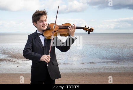 Viktor Seifert, 12, from St Mary's Music School in Edinburgh, plays the Orca Driftwood Viola by the sea at Musselburgh, East Lothian, ahead of his performance at the Royal Academy of Music in London on July 18th 2019, in the 'Dance For The Sea' event which supports the work of the Marine Conservation Society. Stock Photo