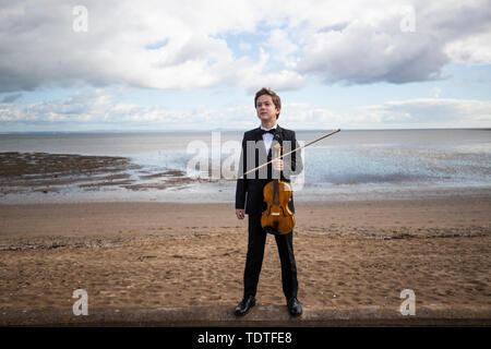 Viktor Seifert, 12, from St Mary's Music School in Edinburgh, plays the Orca Driftwood Viola by the sea at Musselburgh, East Lothian, ahead of his performance at the Royal Academy of Music in London on July 18th 2019, in the 'Dance For The Sea' event which supports the work of the Marine Conservation Society. Stock Photo