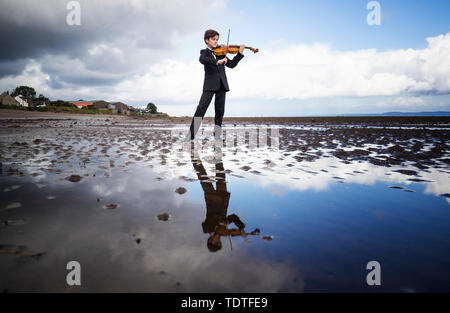 Viktor Seifert, 12, from St Mary's Music School in Edinburgh, plays the Orca Driftwood Viola by the sea at Musselburgh, East Lothian, ahead of his performance at the Royal Academy of Music in London on July 18th 2019, in the 'Dance For The Sea' event which supports the work of the Marine Conservation Society. Stock Photo