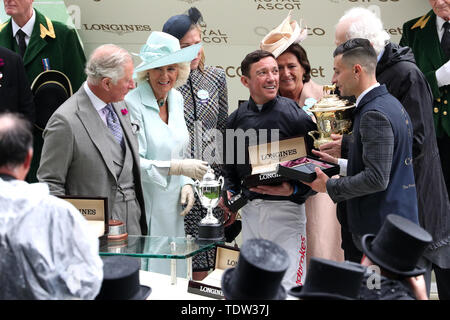 The Duchess of Cornwall (second left) and Prince of Wales (left) present jockey Frankie Dettori (second right) and winning connections with the trophy after winning the Prince of Wales's Stakes with Crystal Ocean during day two of Royal Ascot at Ascot Racecourse. Stock Photo