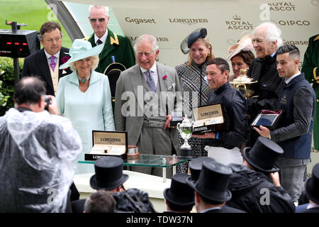 The Duchess of Cornwall (left) and Prince of Wales (second left) present jockey Frankie Dettori (second right) and winning connections with the trophy after winning the Prince of Wales's Stakes with Crystal Ocean during day two of Royal Ascot at Ascot Racecourse. Stock Photo