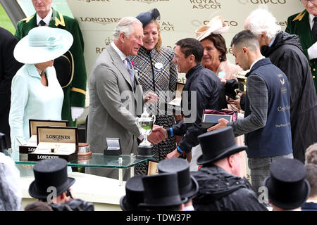 The Duchess of Cornwall (left) and Prince of Wales (second left) present jockey Frankie Dettori (second right) and winning connections with the trophy after winning the Prince of Wales's Stakes with Crystal Ocean during day two of Royal Ascot at Ascot Racecourse. Stock Photo