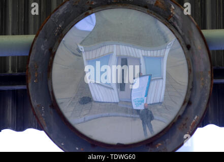 31 May 2019, Saxony-Anhalt, Marienborn: Mirrors for the control of car roofs hang under the roof constructions covered with yellow corrugated polyester at the former passport and customs controls which belong today to the memorial place German division Marienborn. The former border crossing point was the largest and most important checkpoint on the German-German border and was mainly used for transit traffic to West Berlin. Opened in 1974 and covering 10,000 square metres, the covered checkpoints of the former truck, car, veterinary and customs checkpoints are now part of the memorial site. Ph Stock Photo