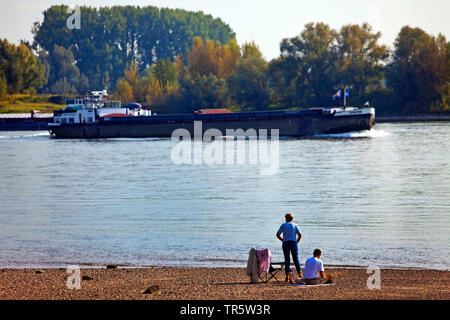 people and cargo ship on Rhine river, Germany, North Rhine-Westphalia, Ruhr Area, Wesel Stock Photo