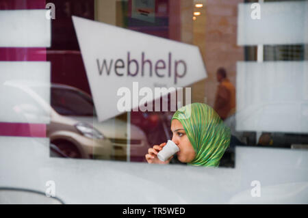 marrokan woman with coffee in an internet cafe, Morocco, Rabat Stock Photo