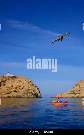 Sea kayaking near the harbour of Ile Rousse, Pietra lighthouse in background, France, Corsica, Ile-Rousse Stock Photo