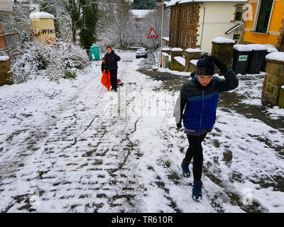 children with ski bob on a street, Germany, North Rhine-Westphalia, Ruhr Area, Witten Stock Photo