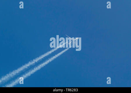 airplane A330 of with vapor trails in the sky Stock Photo
