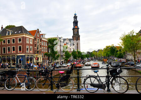 bridge at Leliegracht with view of Prinzengracht with round trip boats, church Westerkerk and Anne-Frank-House, Netherlands, Northern Netherlands, Amsterdam Stock Photo