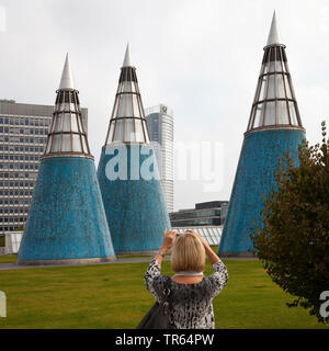 woman taking pictures of the conical light wells on the roof garden of the Art and Exhibition Hall, Germany, North Rhine-Westphalia, Bonn
