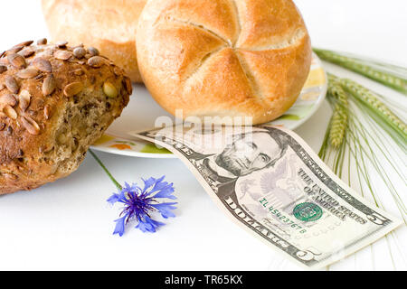 bread roll s with 5 dollar bill, cornflower and barley, USA Stock Photo