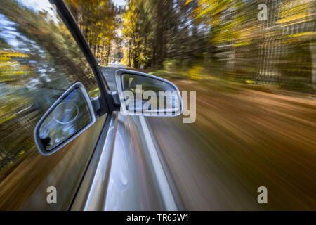 Car driving on a street in autumn, Germany, Bavaria Stock Photo