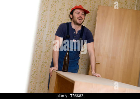 removalist having a break, drinking a beer Stock Photo