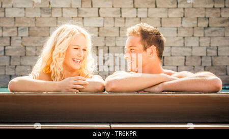 young couple relaxing at a pool, Germany Stock Photo