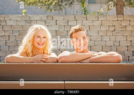 young couple relaxing at a pool, Germany Stock Photo