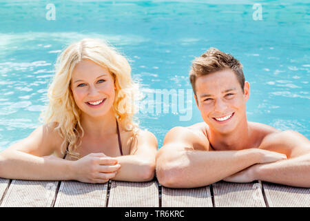 young couple relaxing at a pool, Germany Stock Photo